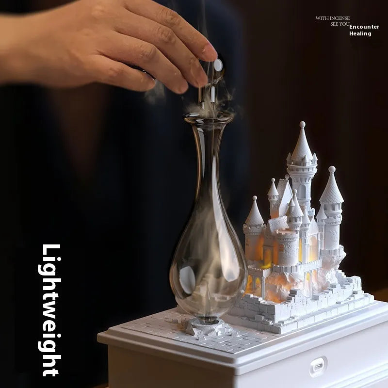 White medieval castle design waterless aromatherapy machine with ambient light on a table.
