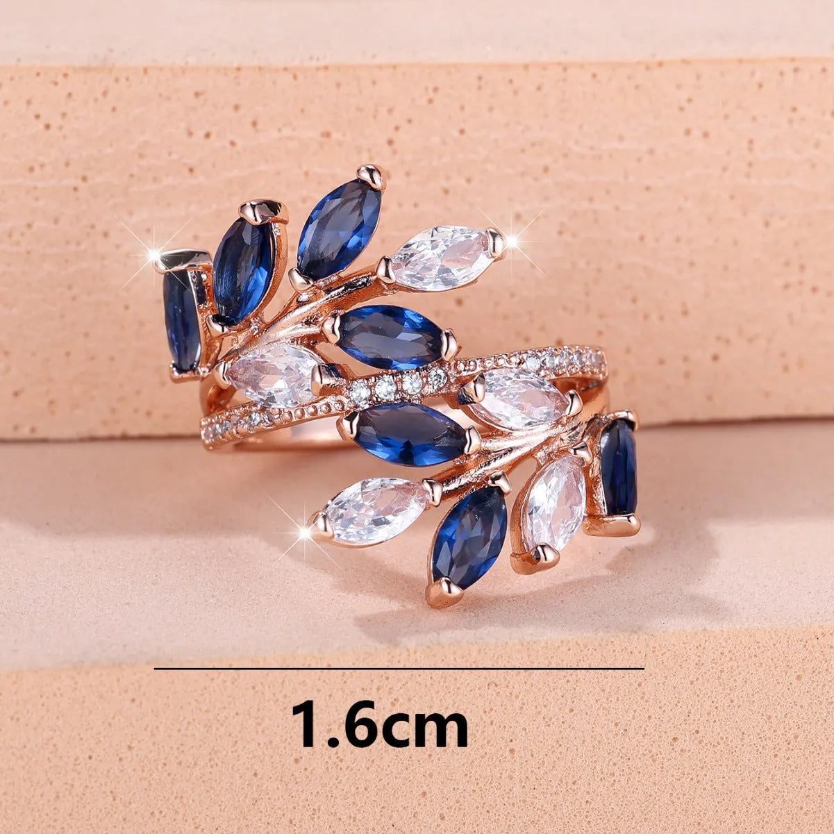 Adjustable opening copper leaf fashion ring with sparkling zirconia stones in a rose gold finish.