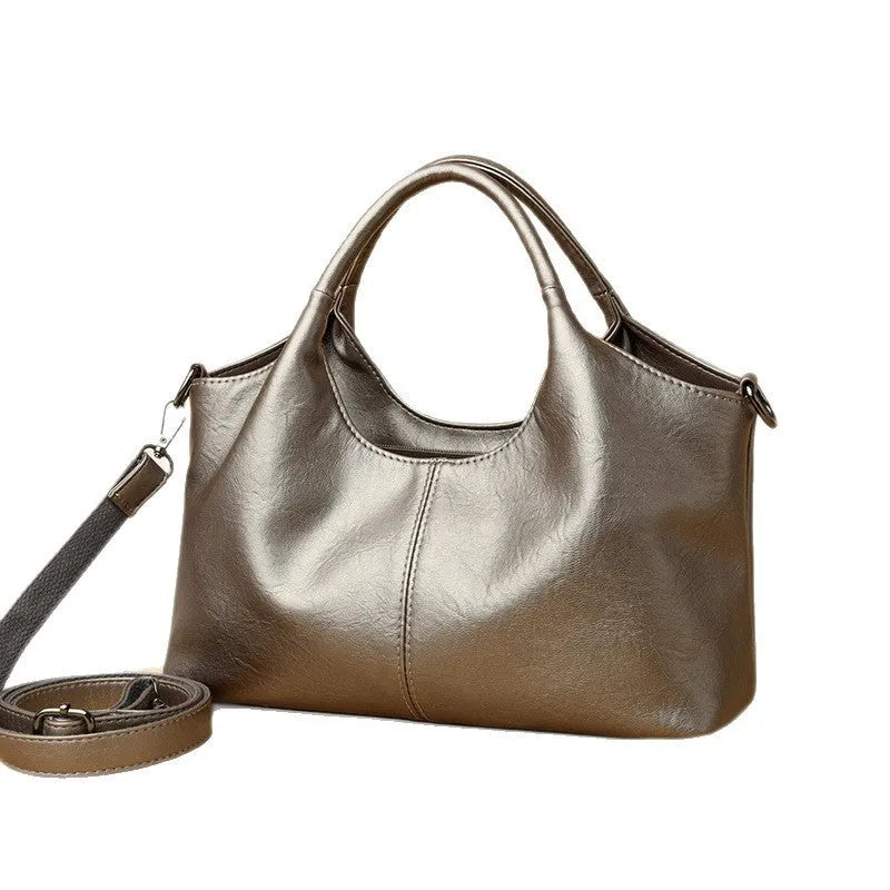 Genuine leather women's cross-body bag in black with adjustable shoulder strap showing interior polyester lining