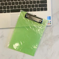 A4 transparent plate holder with metal clip holding documents in office setting