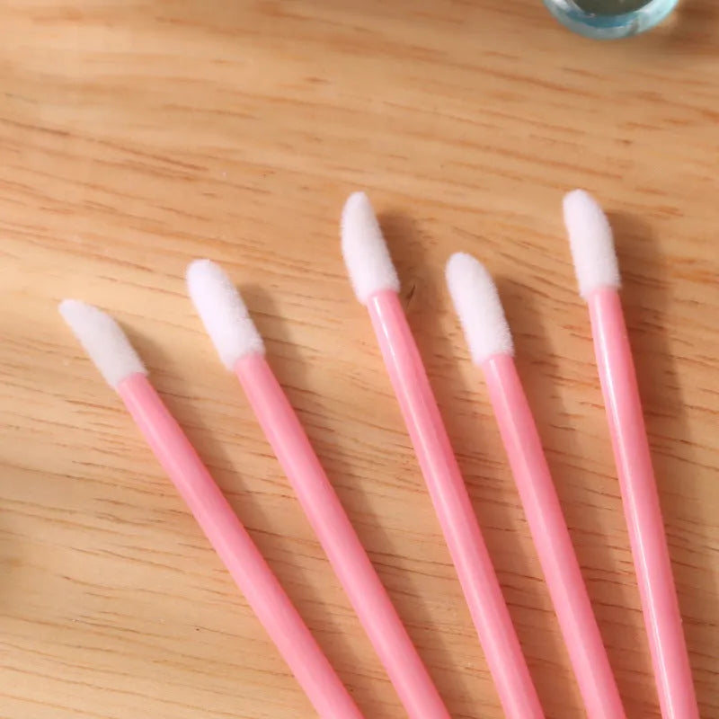Disposable lip brushes with black handles and flocked tips in bulk packaging for lipstick and gloss application
