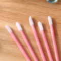 Disposable lip brushes with black handles and flocked tips in bulk packaging for lipstick and gloss application