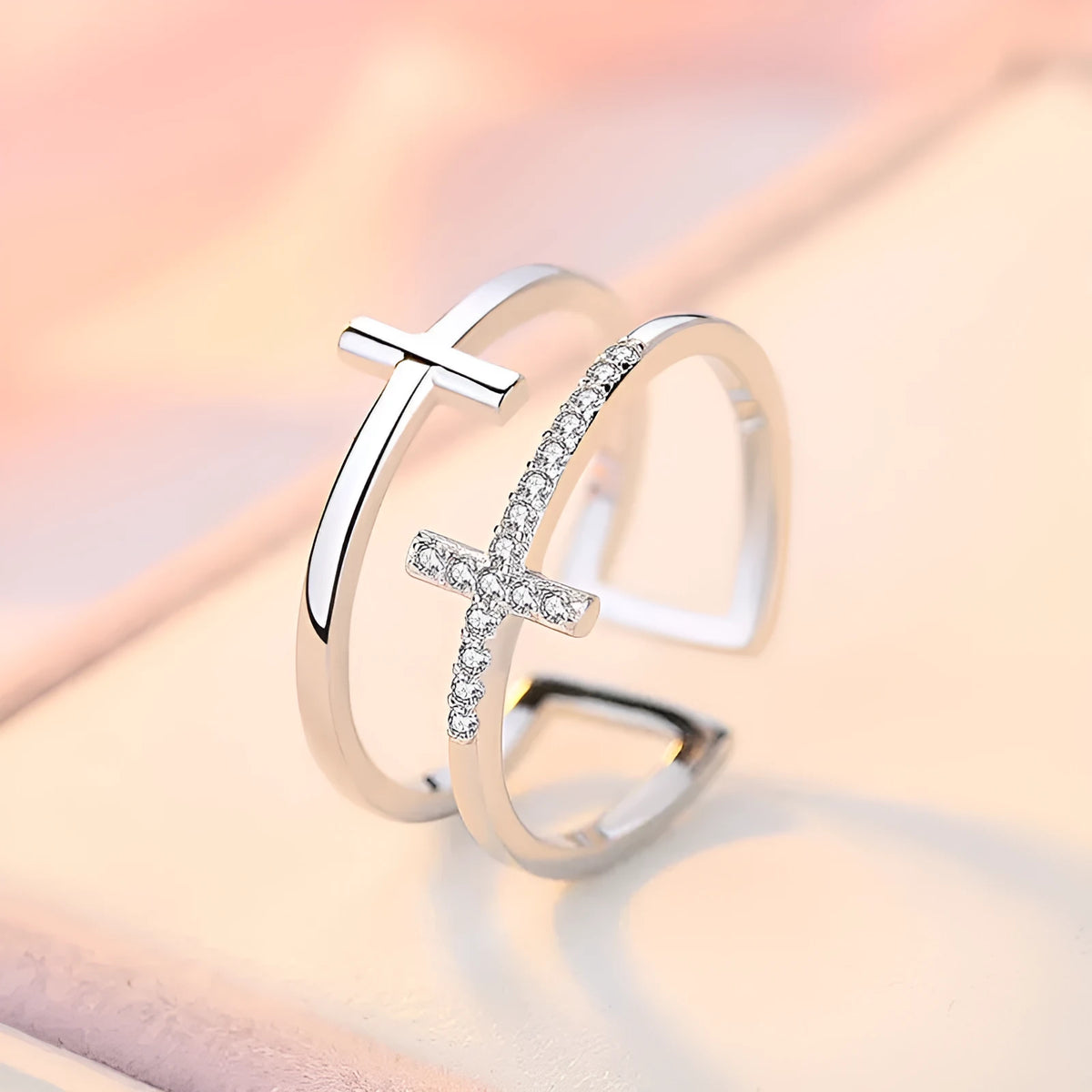 Adjustable open ring showing double cross design with zircon stones and sterling silver inlay on copper.