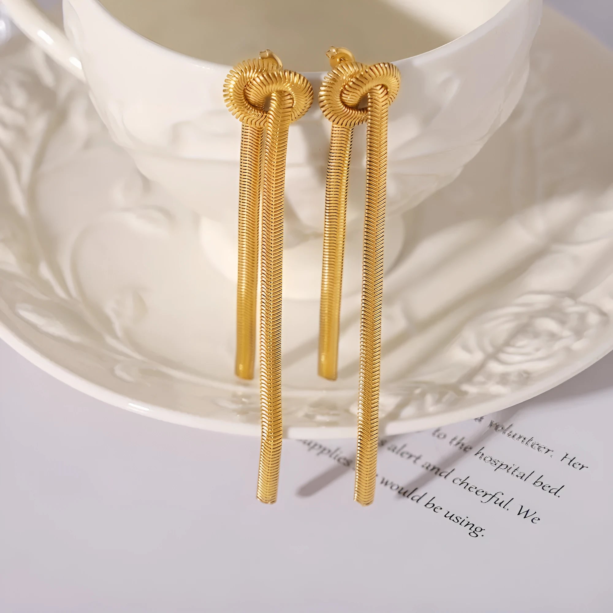 Gold titanium steel necklace with knotted tassel pendant and matching earrings set