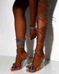 Plus size black strappy high-heeled sandals with rhinestone decoration on a square toe.