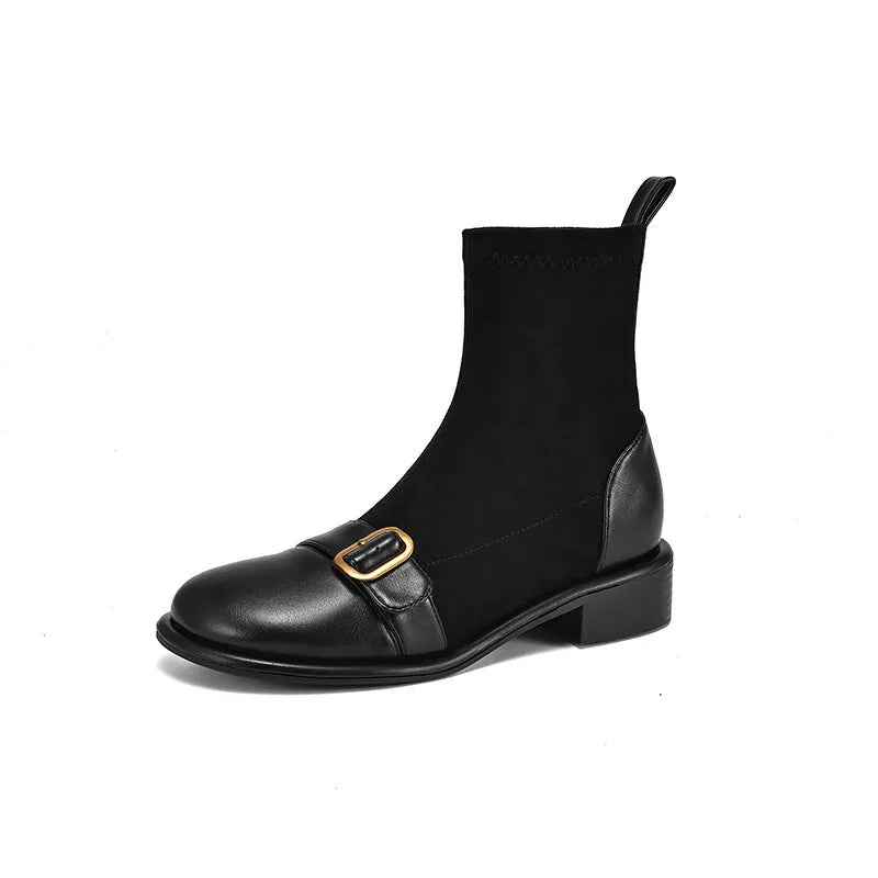 Women's black low heel Martin boots with front lace-up and belt buckle stitch detailing on a white background.