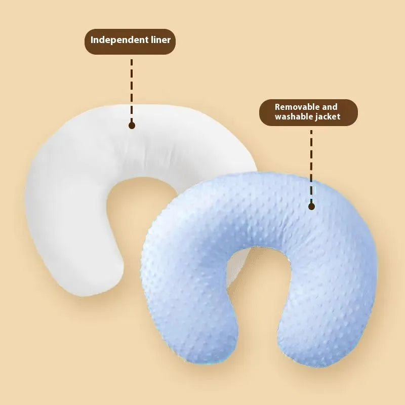 Grey nursing pillow with milk spill prevention feature for breastfeeding support