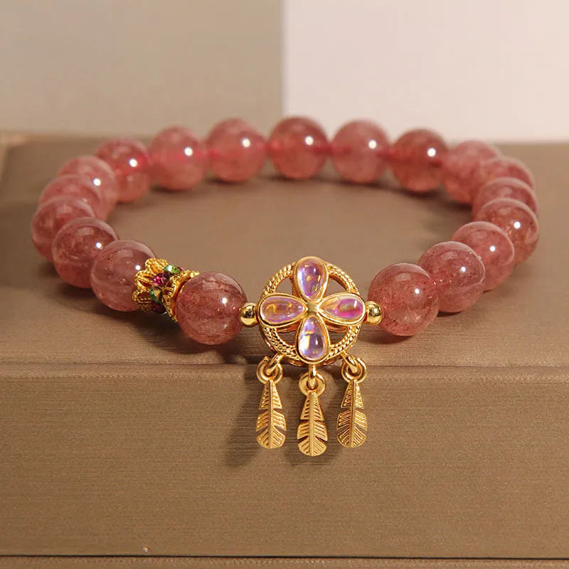 Women's bracelet with a strawberry quartz dream catcher ball pendant on a crystal chain.