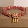 Women's bracelet with a strawberry quartz dream catcher ball pendant on a crystal chain.
