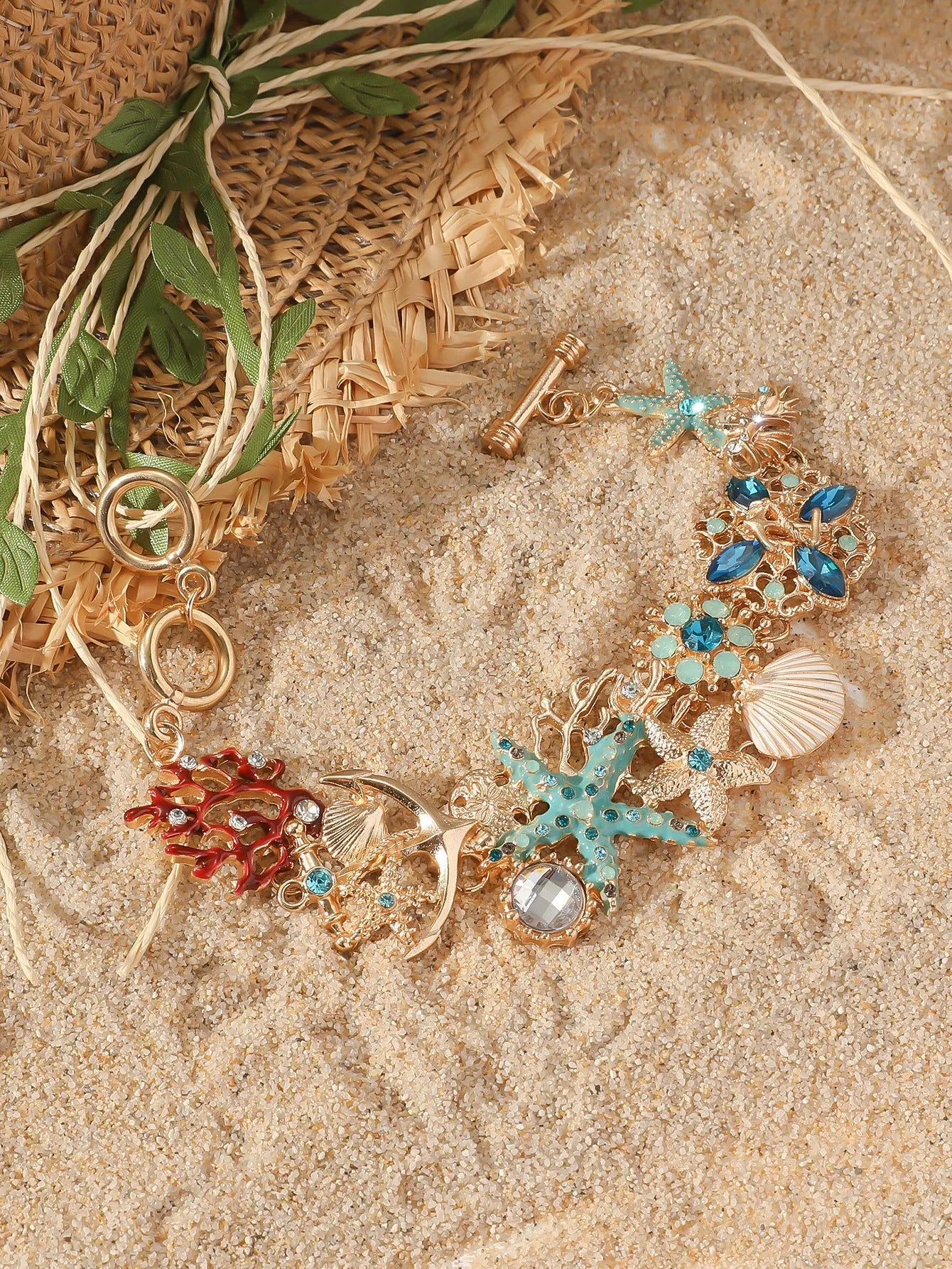 Women's alloy rhinestone marine shell and anchor bracelet with starfish charm in turquoise colour.