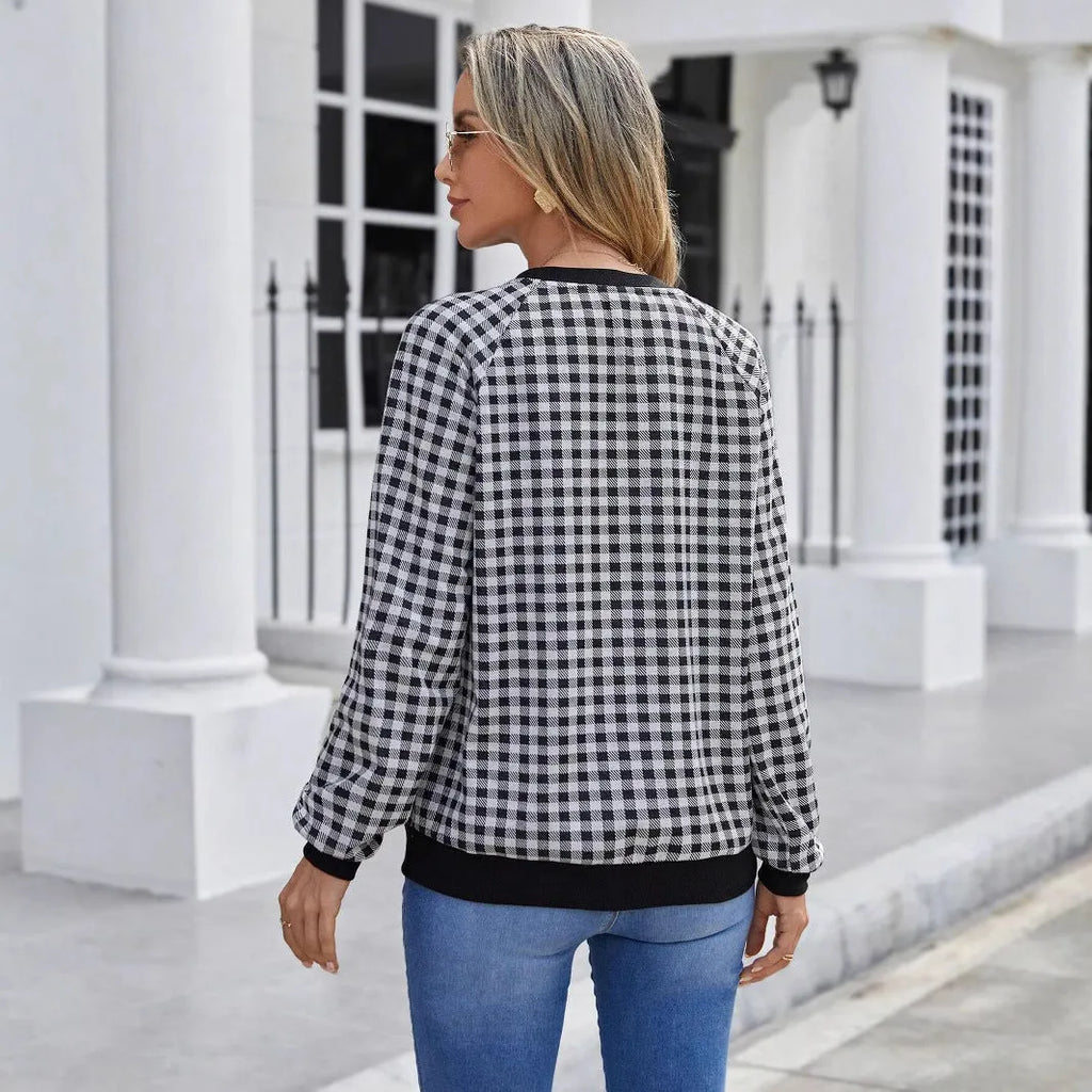 Black long sleeve pullover sweater with a Japanese plaid pattern, shown on a hanger.