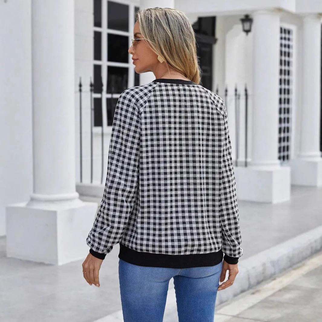 Black long sleeve pullover sweater with a Japanese plaid pattern, shown on a hanger.