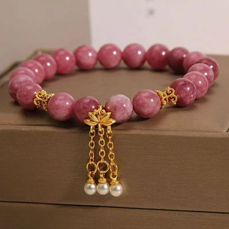Natural stone bracelet with lotus tassel design, pearl pendant, and electroplated pink finish