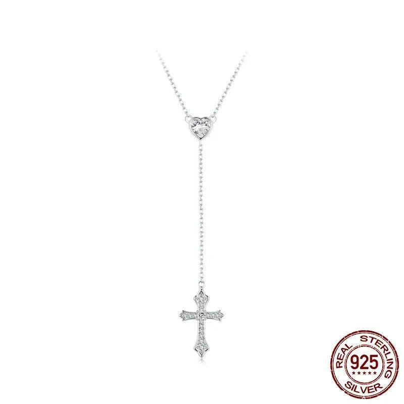 Close-up of a silver love cross necklace with an adjustable O-ring chain on an antique BSN384 finish.