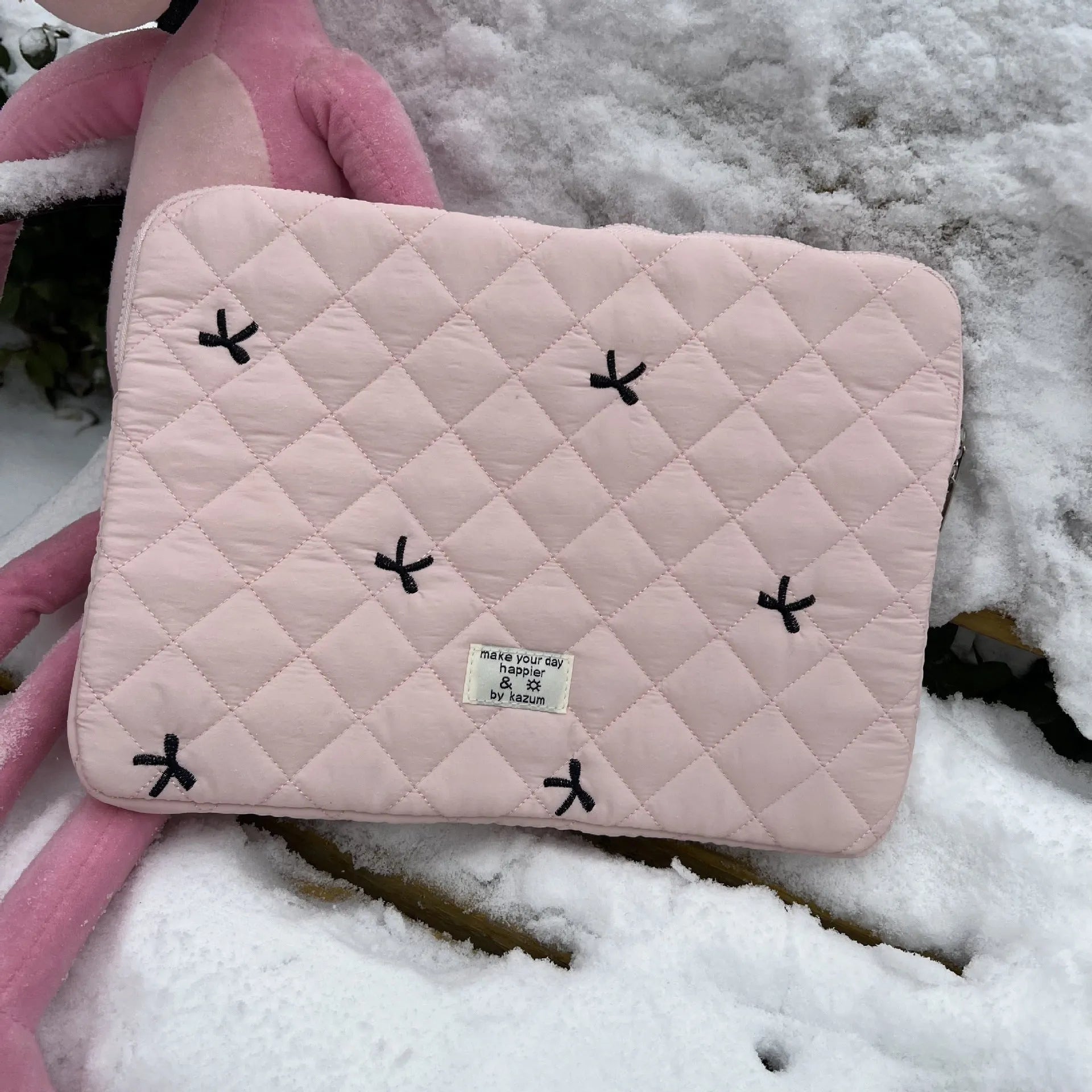 Nylon laptop storage bag with rhombus embroidery and bow in light blue, showing front detail