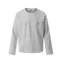 Man wearing a grey loose fit cotton long sleeve pullover with a simple retro design.