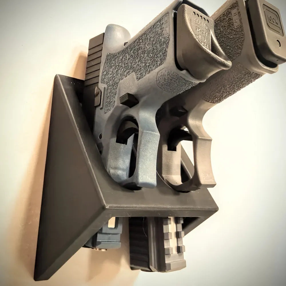 Black punk-style plastic pistol display stand for collectible airsoft pistols and models.