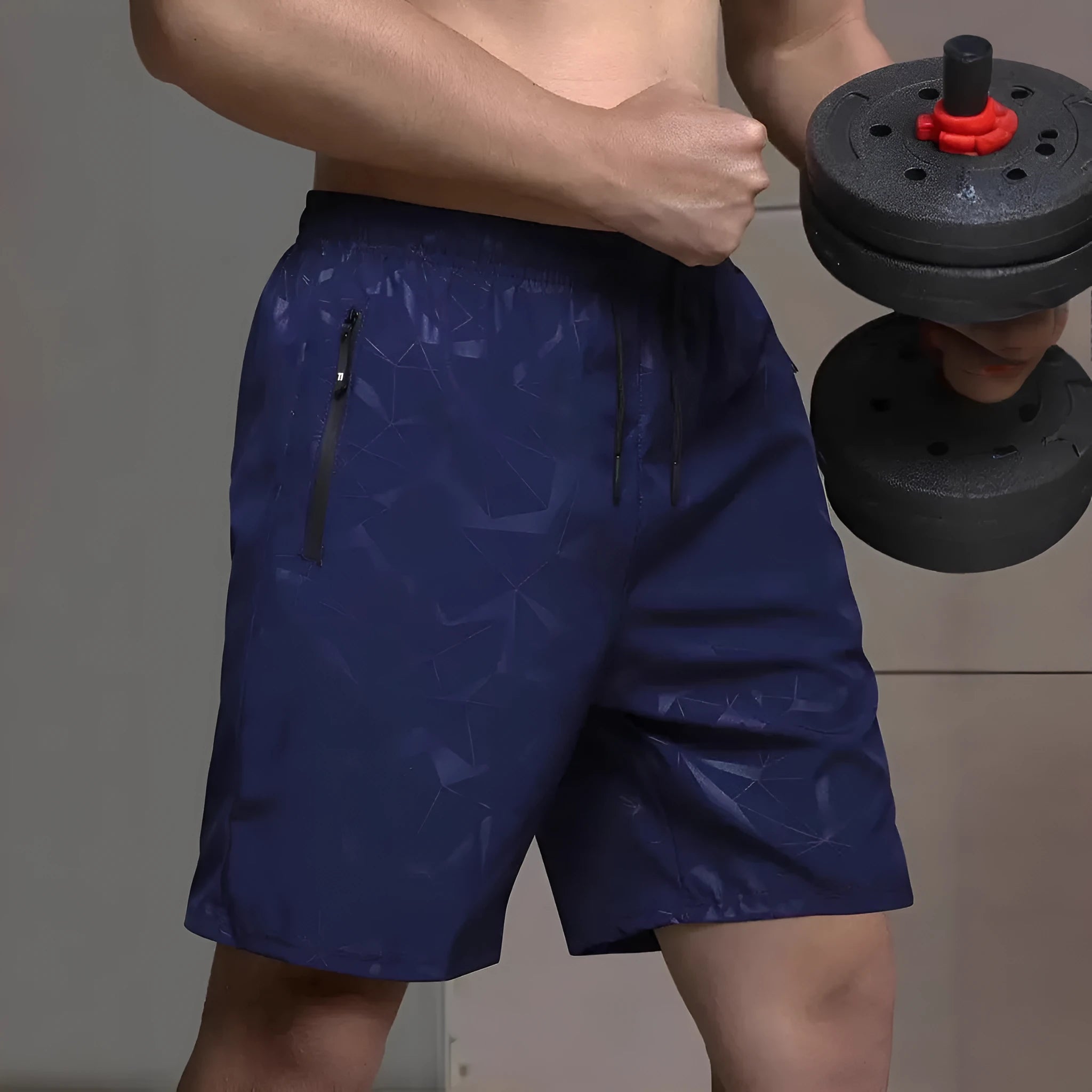 Man wearing loose grey polyester sports shorts on a beach