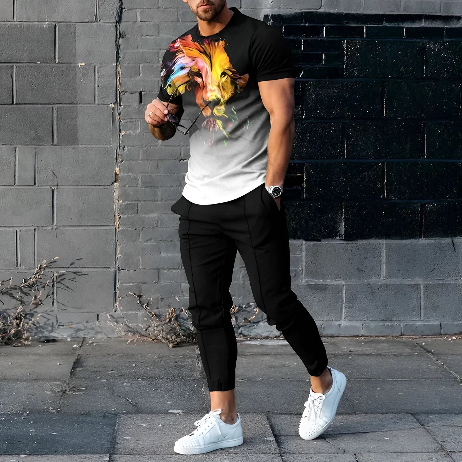 Men's grey printed short-sleeved tracksuit top and trousers laid flat.