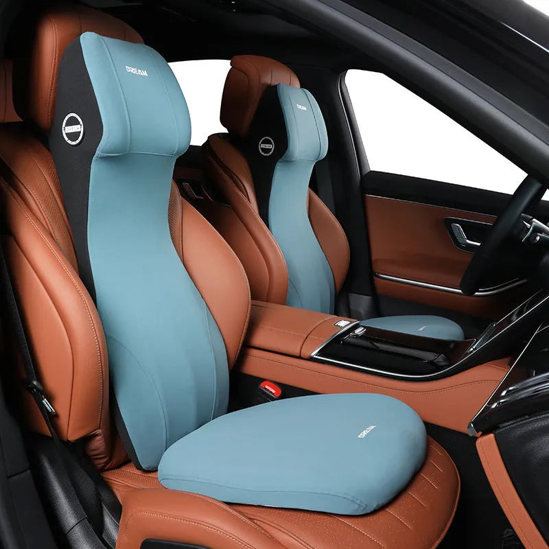 Black automotive memory foam cushion and lumbar support pillow set on a car seat.