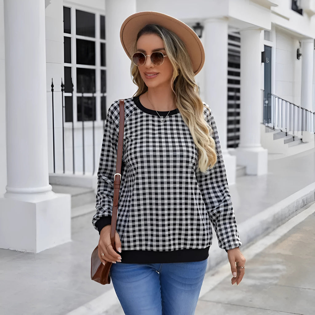 Black long sleeve pullover sweater with a Japanese plaid pattern, shown on a hanger.