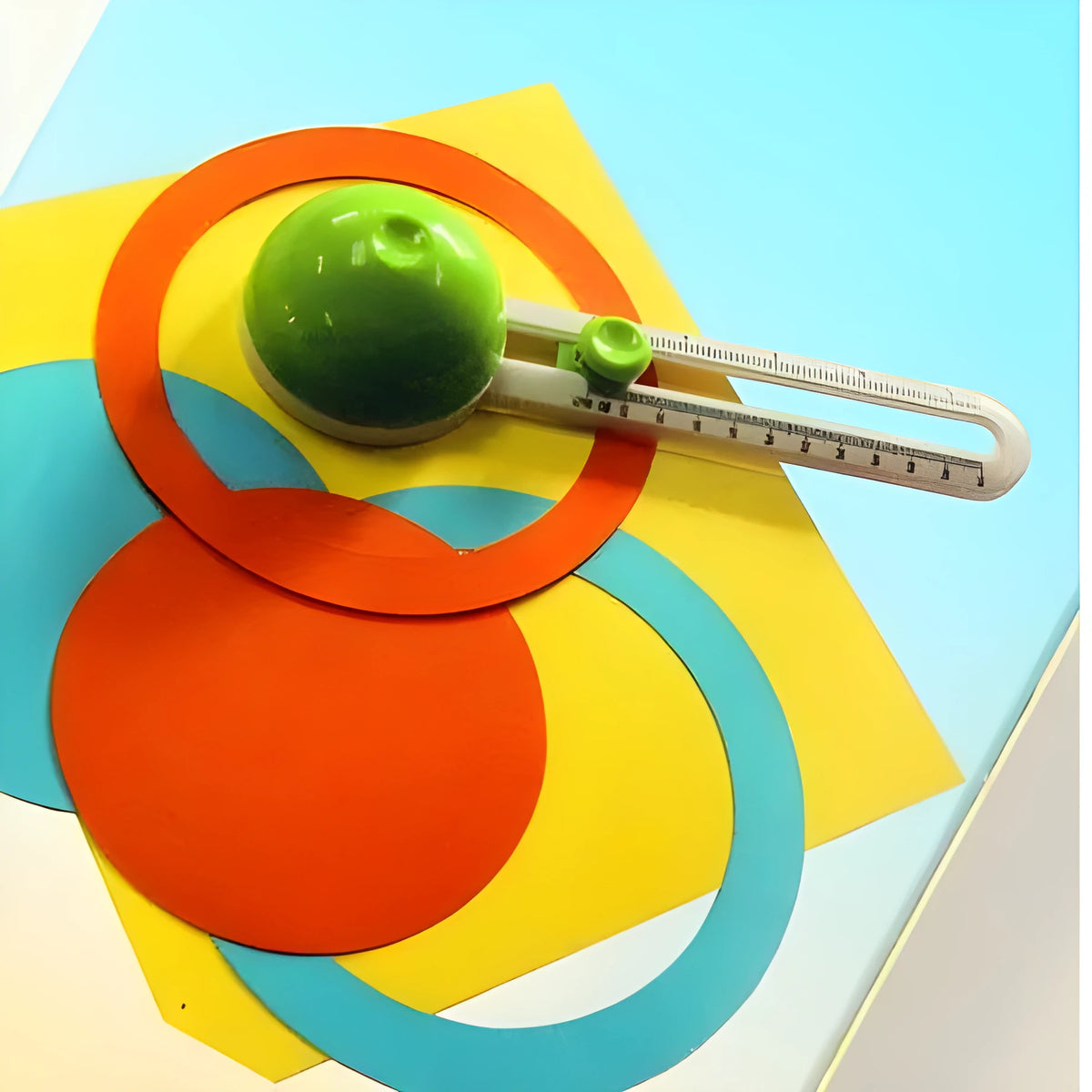 Green or orange plastic A3 round paper cutter for juvenile use.