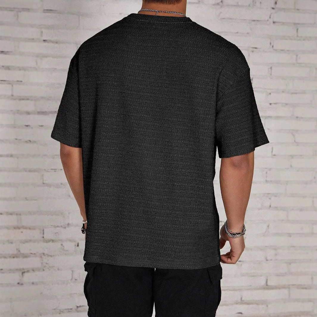 Men's slim-fit loose t-shirt in light blue solid colour, showing round neck and short sleeves.