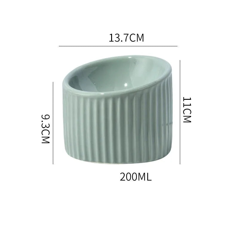 Elevated ceramic cat bowl in green colour showing raised, tilted design for food or water.