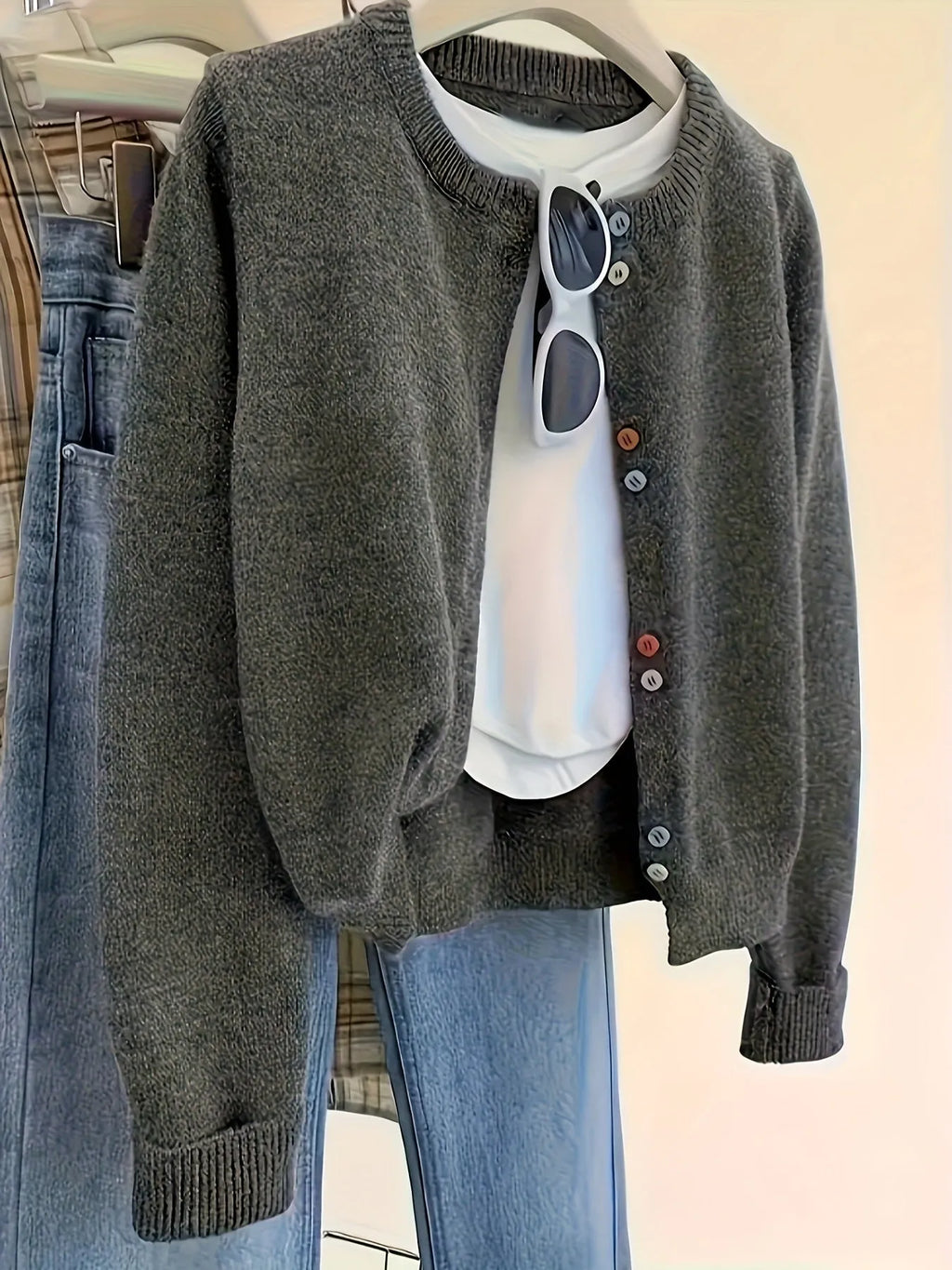 Dark grey women's cardigan sweater with button front and long sleeves.