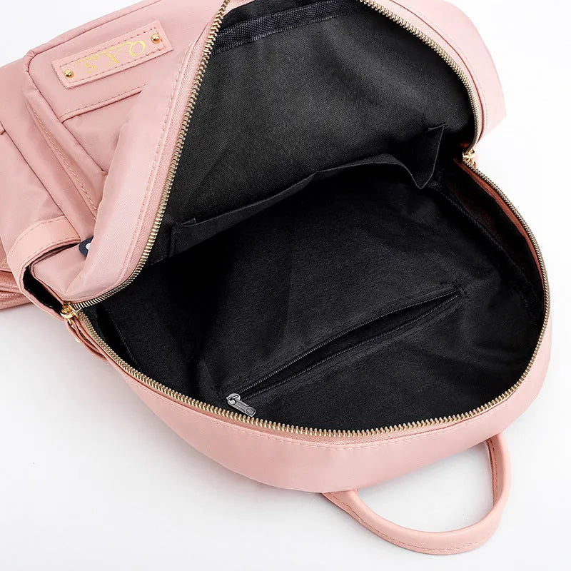 Women's black casual nylon backpack with multiple pockets and soft shoulder straps