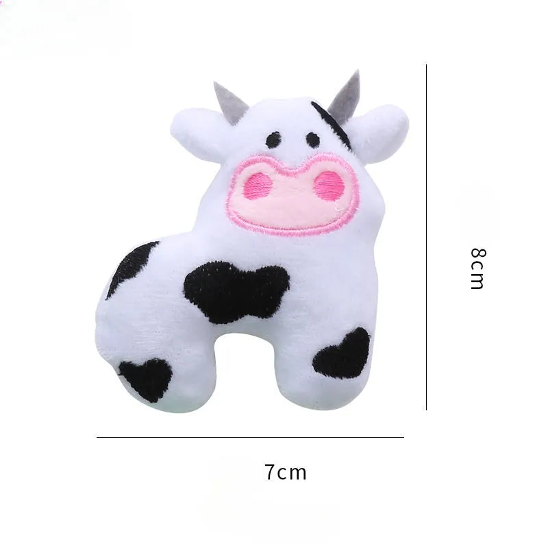 Cow shaped plush cat toy on a string handle with dangling feather, catnip inside.