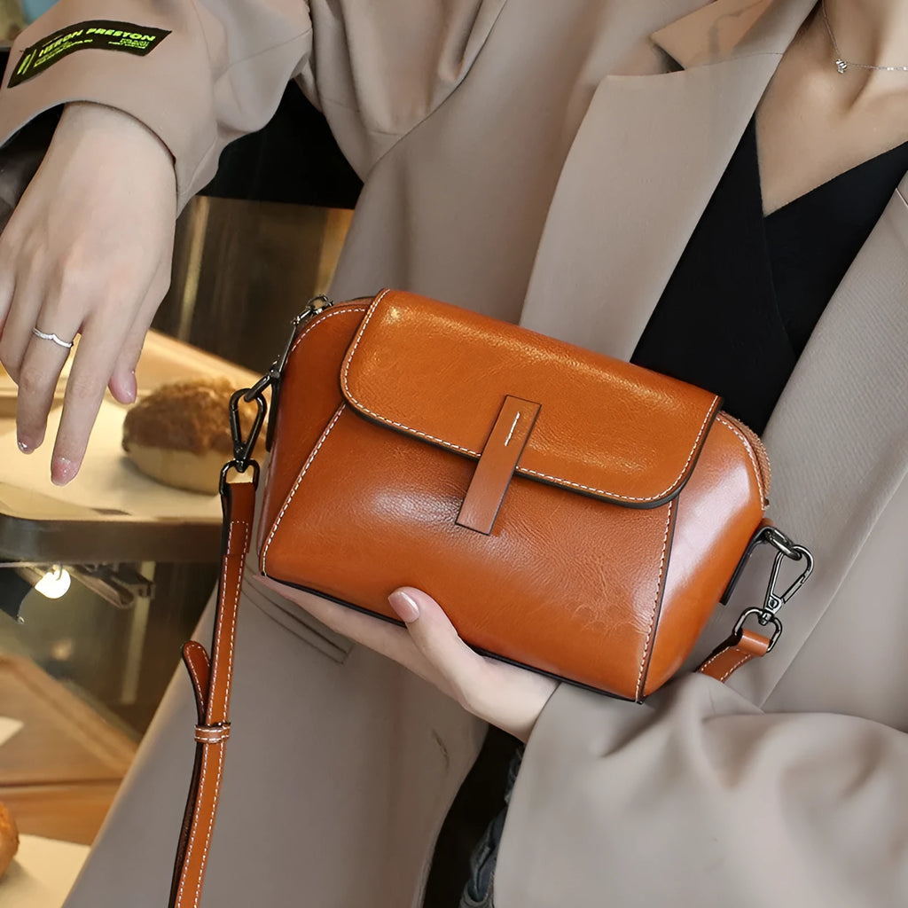 Women's brown oil wax cowhide leather shell shape messenger bag with cross-body strap and interior compartments
