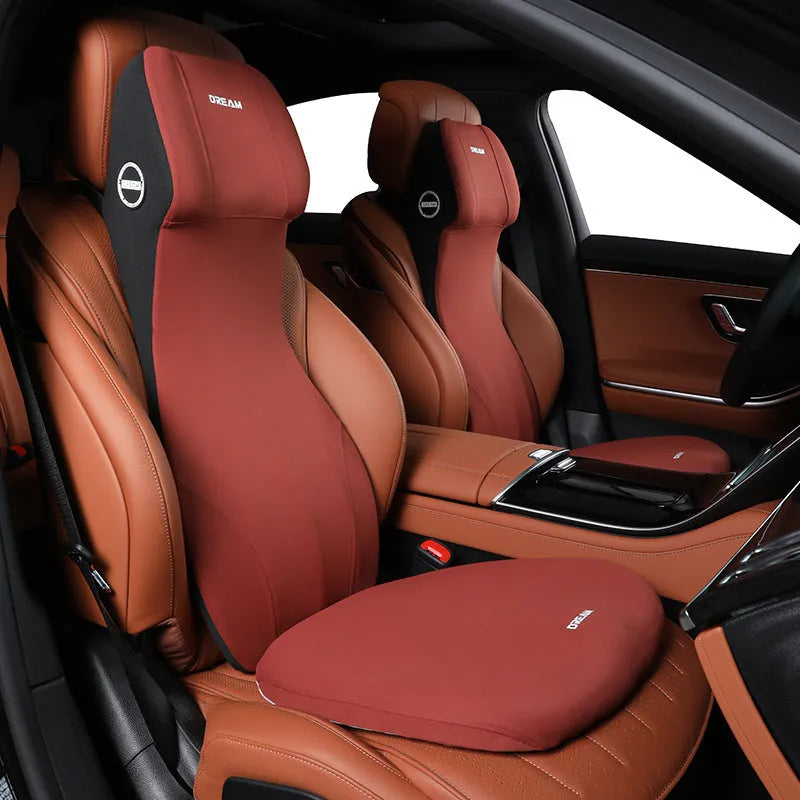 Black automotive memory foam cushion and lumbar support pillow set on a car seat.
