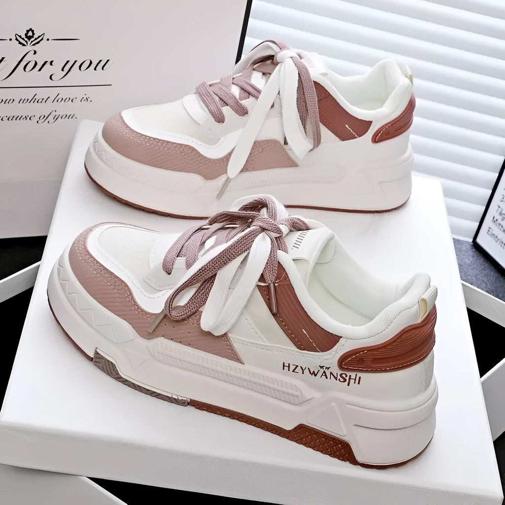 Children's beige board shoes with thick rubber sole, cross shoulder straps, and lace-up front.