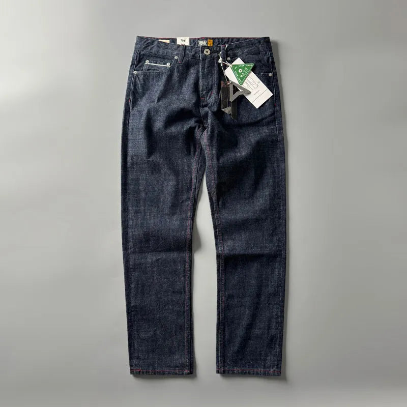 Men's straight leg denim trousers in a primary colour, showing the mid waist fit and long leg.
