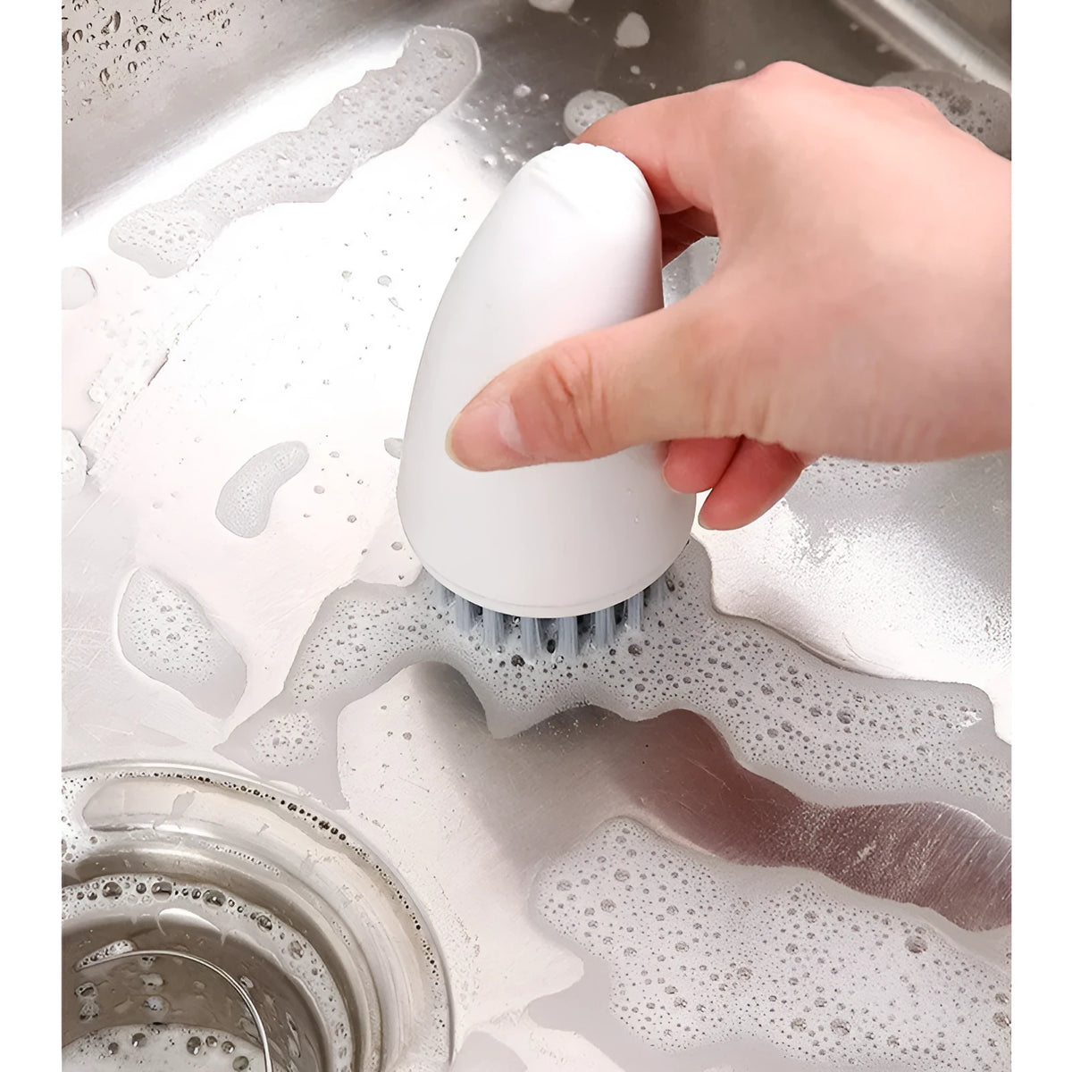 Carrot-shaped orange and white kitchen cleaning brush with nylon bristles
