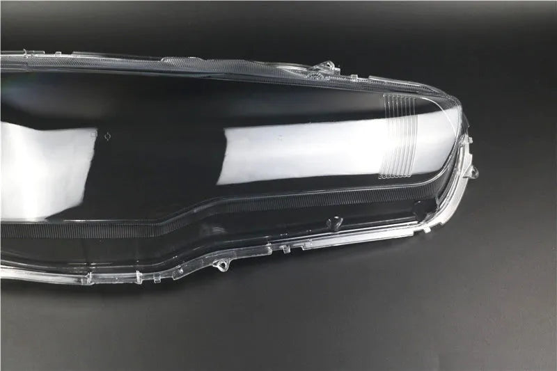 Transparent plastic headlight housing cover measuring 50x30x20mm for vehicle lampshade protection