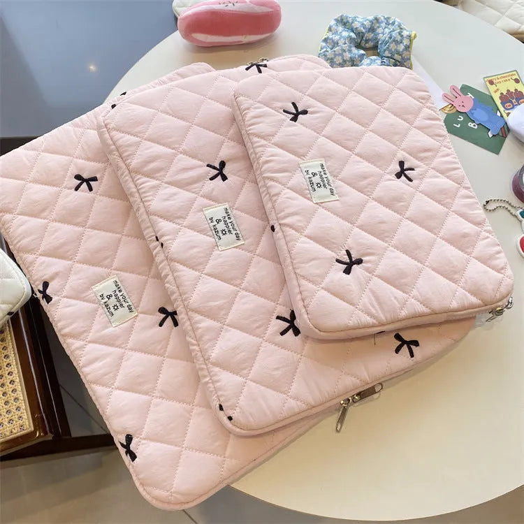 Nylon laptop storage bag with rhombus embroidery and bow in light blue, showing front detail