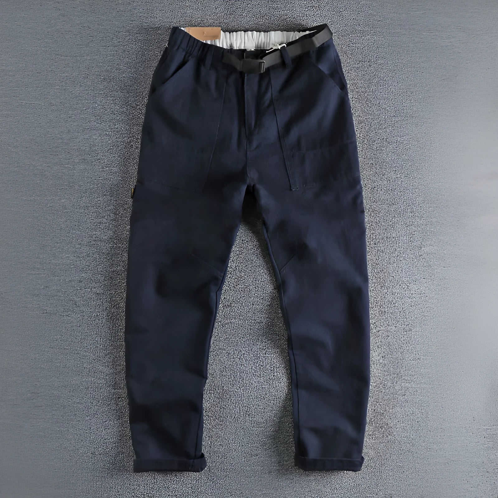 Men's khaki cotton work trousers with mid waist and zipper fly on a neutral background