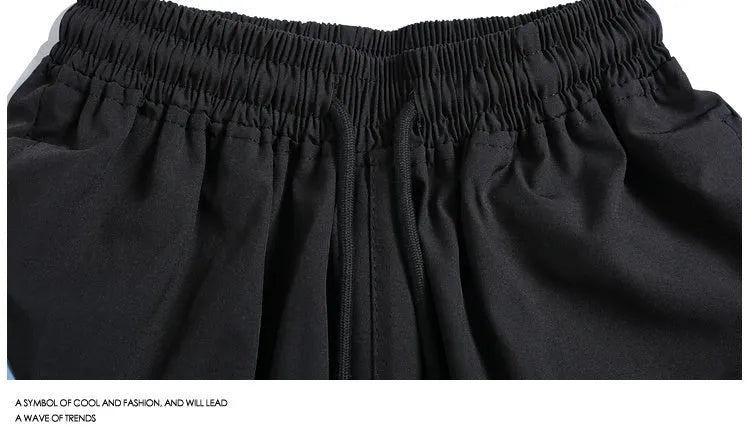 Men's black quick-drying sports shorts with elastic waist and straight-leg loose fit