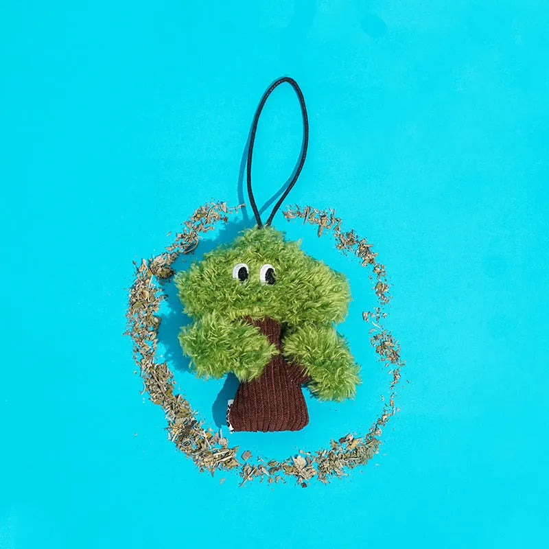 Pine tree-shaped hanging cat chew toy with mint filling, shown next to a ruler for scale