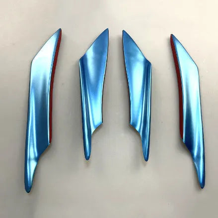 Set of four carbon fibre pattern automotive bumper blades mounted on vehicle