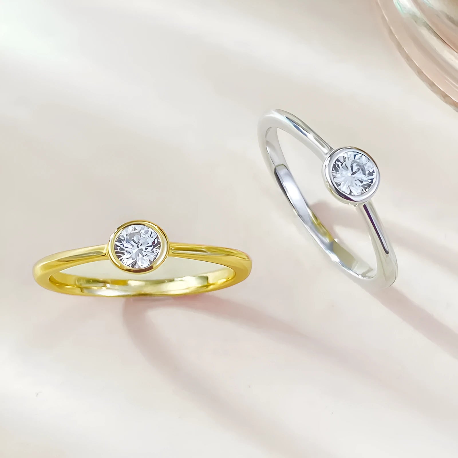 Minimalist crown shape silver ring electroplated in gold or platinum colour on a plain background.