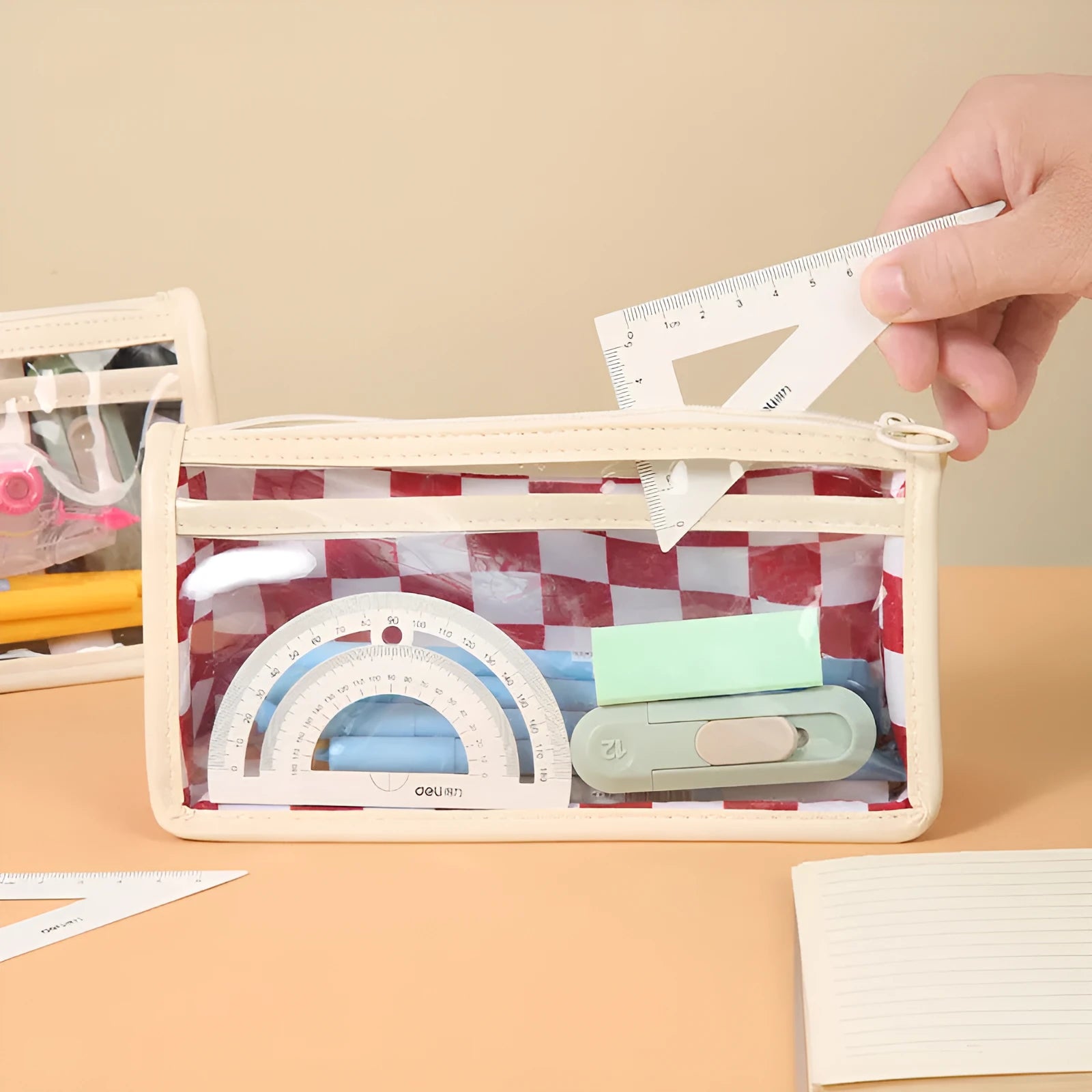Transparent PVC pencil case with chessboard pattern showing pens inside