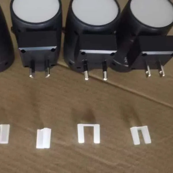 Plug-in night lamp with adjustable brightness dial and rotatable light head showing warm illumination