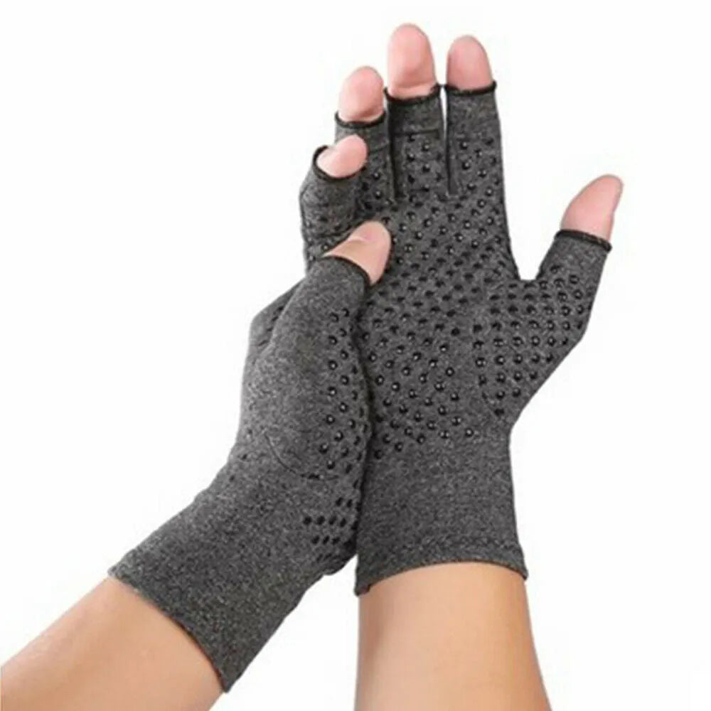 Grey half-finger joint compression gloves with anti-slip grip on a flat surface.