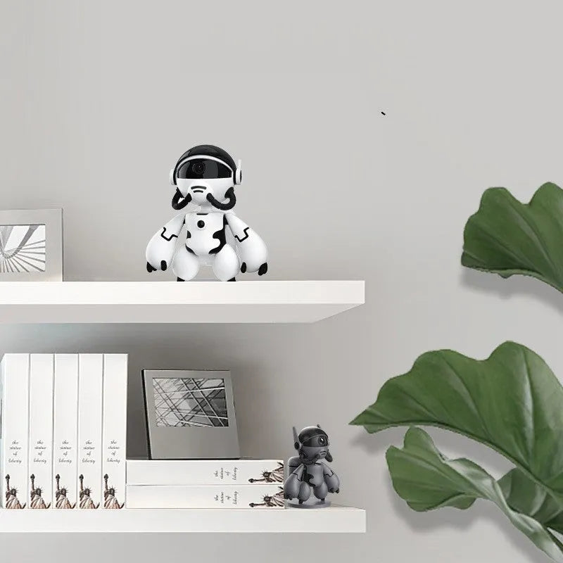 White wireless security camera with detachable base on a table for home monitoring.