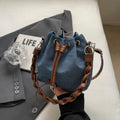 Blue synthetic leather cross-body bucket bag with adjustable strap and optional hanging drop decoration