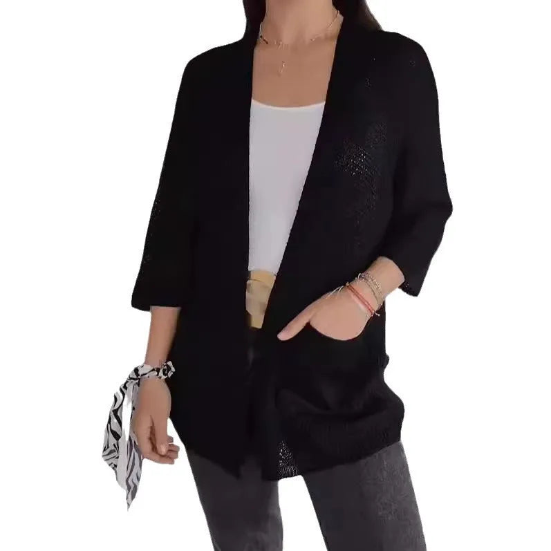 Women's army green waffle knit cardigan coat with nine-quarter sleeves and pockets laid flat.