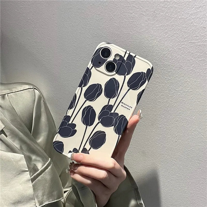Black silicone iPhone case with a large tulip flower design on the back.